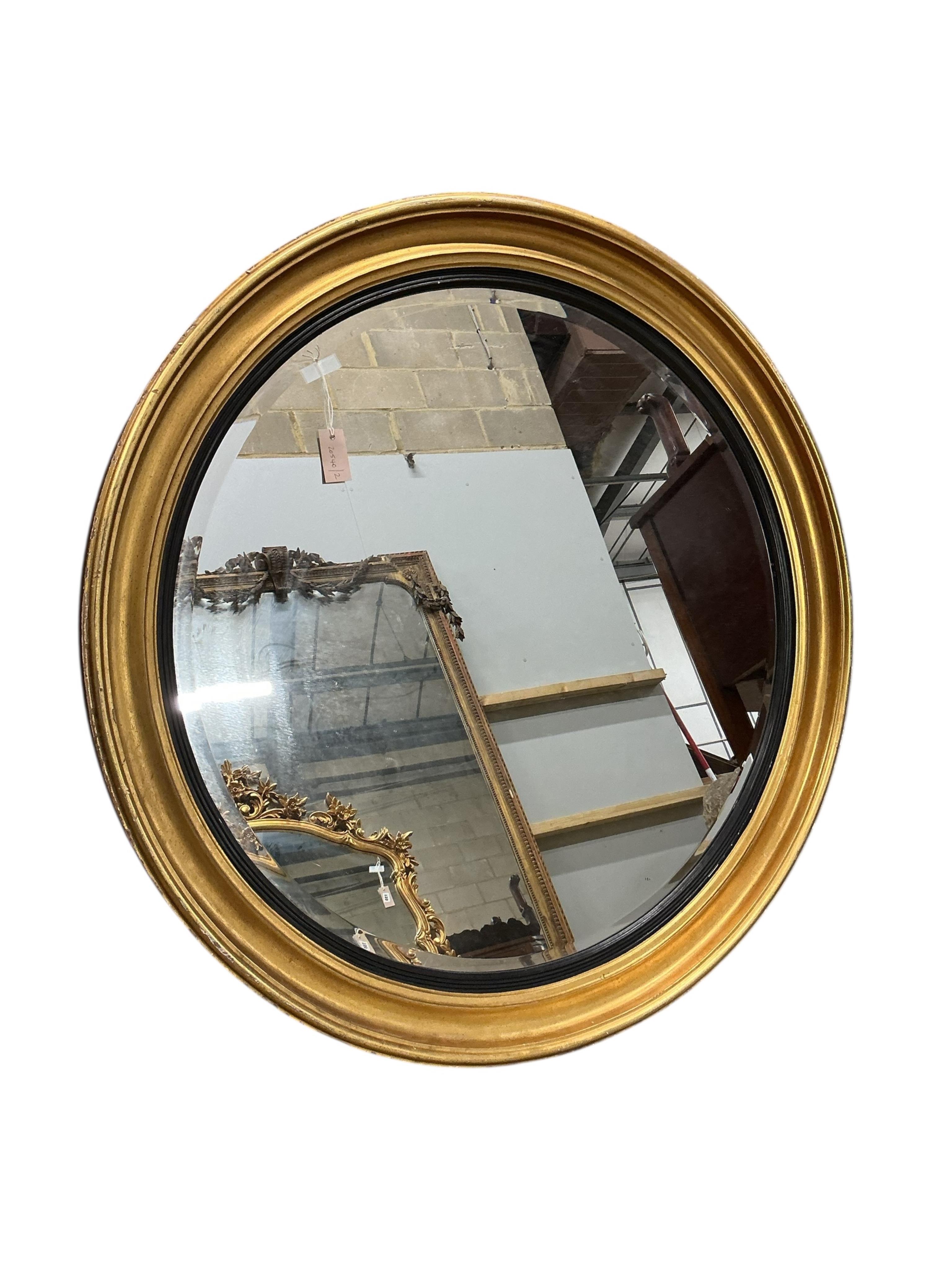 A large Regency style circular giltwood wall mirror with ebonised slip, diameter 120cm